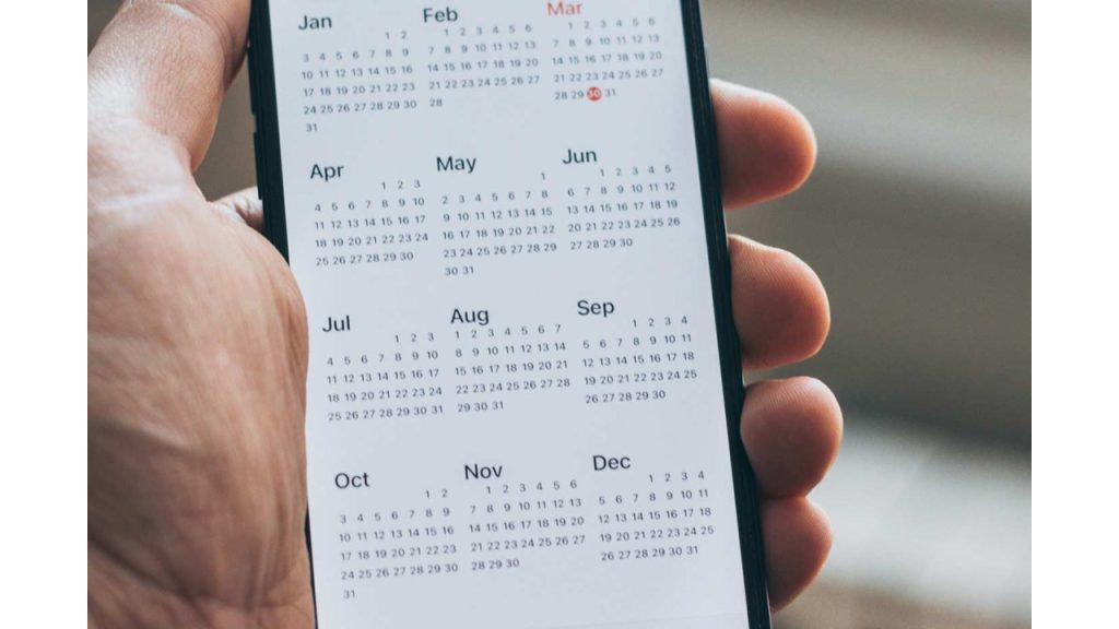 Someone looking at the calendar on their phone. 