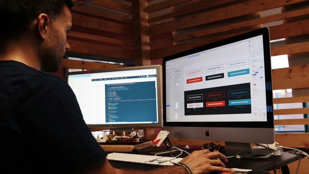 A man working on graphic design on a computer. 